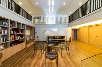 a living room with a table and chairs and a couch at The Residence on Thonglor by UHG in Bangkok