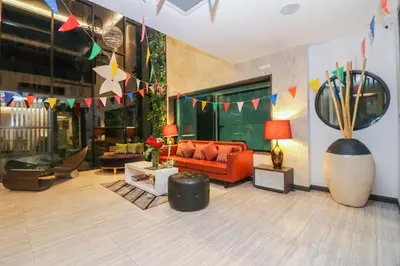 a living room with a couch and chairs and flags at Aim House Bangkok No Parking in Bangkok