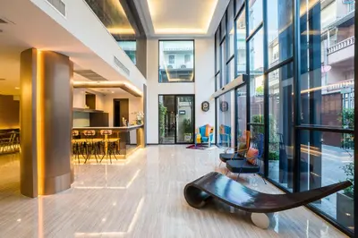 a lobby with a bench in the middle of a building at Aim House Bangkok No Parking in Bangkok