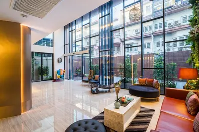 an office lobby with a large glass wall at Aim House Bangkok No Parking in Bangkok