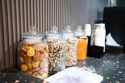 a group of glass jars filled with different types of nuts at Infinite Hotel-Ratchada in Bangkok