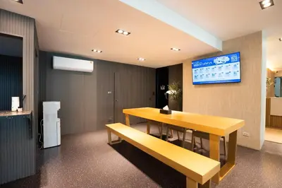 a conference room with a table and a bench at Infinite Hotel-Ratchada in Bangkok