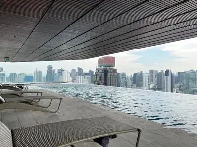 a swimming pool on top of a building with a city at The Fine 2-bedroom in Bangkok