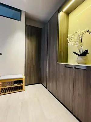 a room with a vase with white flowers in it at The Fine 2-bedroom in Bangkok