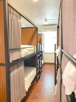 a room with two bunk beds in a room at Kudi Hostel in Bangkok