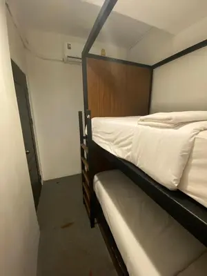 two bunk beds in a small room at Kudi Hostel in Bangkok