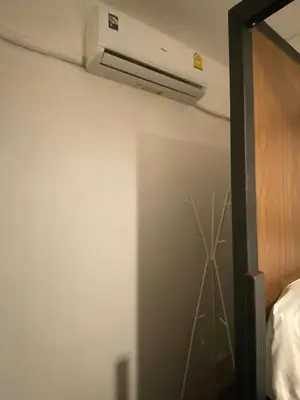 a room with a air conditioner on the ceiling at Kudi Hostel in Bangkok