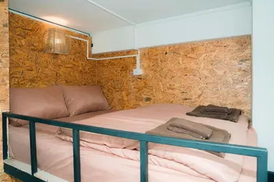 a bedroom with a bunk bed in a room at Comfy Corner Hostel in Bangkok