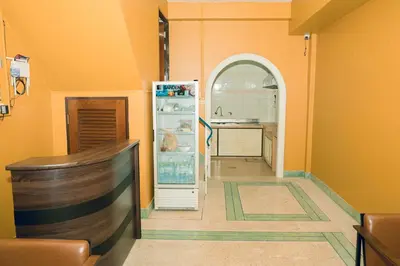a kitchen with an open refrigerator in a room at Comfy Corner Hostel in Bangkok