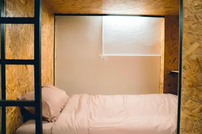a bedroom with a bunk bed and a window at Comfy Corner Hostel in Bangkok