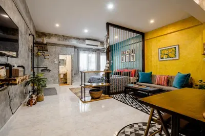 a living room with a couch and a table at Double Studio with Balcony & Private Bath by Smile Loft in Bangkok
