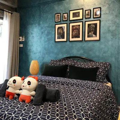 two hello kitty stuffed animals sitting on a bed at Double Studio with Balcony & Private Bath by Smile Loft in Bangkok