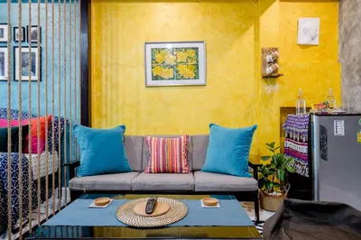 a living room with a couch and a table at Double Studio with Balcony & Private Bath by Smile Loft in Bangkok