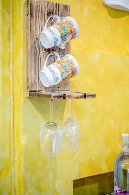 a wine rack with wine glasses and wine bottles at Double Studio with Balcony & Private Bath by Smile Loft in Bangkok