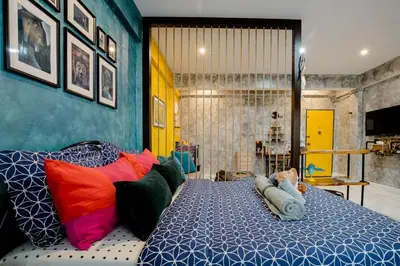 a bedroom with a bed with colorful pillows at Double Studio with Balcony & Private Bath by Smile Loft in Bangkok