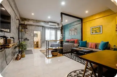 a living room with a couch and a table at Double Studio with Balcony & Private Bath by Smile Loft in Bangkok