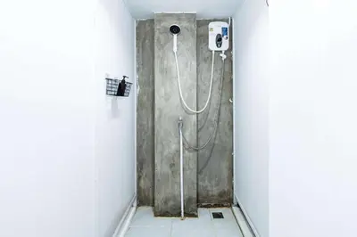 a shower stall in a bathroom with a shower at XX The Hidden Khaosan - เดอะฮิดเด้นถนนข้าวสาร รามบุตรี in Bangkok