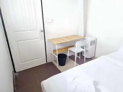 a small room with a table and a desk with a chair at XX The Hidden Khaosan - เดอะฮิดเด้นถนนข้าวสาร รามบุตรี in Bangkok