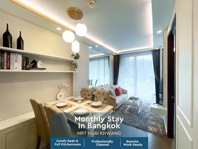 a magazine advert for a living room with a table and chairs at Comfortable Stay 1BR - Ultra Fast Wifi - Huai Khwang in Bangkok