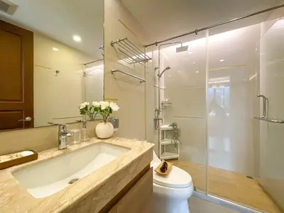 a bathroom with a large tub and a glass shower at Comfortable Stay 1BR - Ultra Fast Wifi - Huai Khwang in Bangkok
