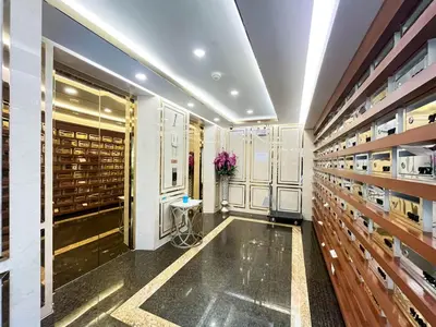 a wine cellar with wooden shelves and a room filled with wine bottles at Comfortable Stay 1BR - Ultra Fast Wifi - Huai Khwang in Bangkok