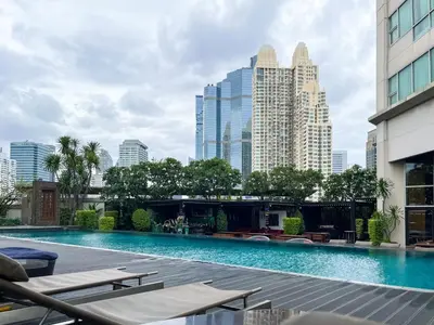a swimming pool with a city skyline in the background at Loft style Large 69 SQMFast WiFi BTS Chong Nonsi in Bangkok