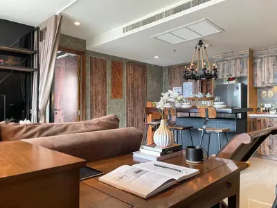 a living room with a couch and a table at Loft style Large 69 SQMFast WiFi BTS Chong Nonsi in Bangkok