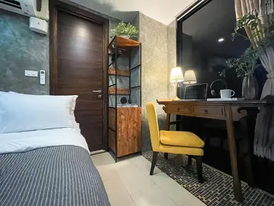 a bedroom with a desk and a bed and a desk and chair at Loft style Large 69 SQMFast WiFi BTS Chong Nonsi in Bangkok