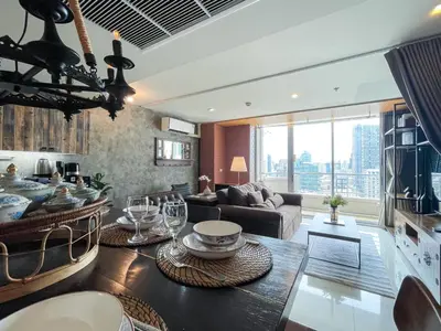 a living room with a couch and a table at Loft style Large 69 SQMFast WiFi BTS Chong Nonsi in Bangkok
