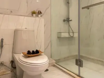 a bathroom with a toilet with a bowl on the seat at Spacious City 118 SQM Fast WiFi BTS Chong Nonsi in Bangkok