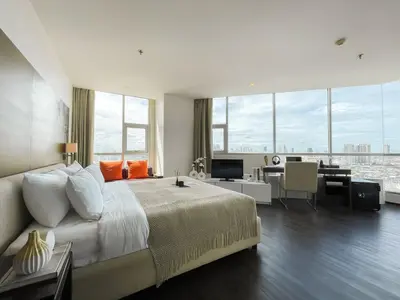 a large bedroom with a large bed and a desk at Spacious City 118 SQM Fast WiFi BTS Chong Nonsi in Bangkok