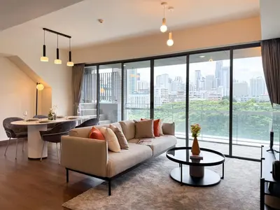 a living room with a couch and a table at Expansive Luxury 2BR - Ultra Fast Wifi - Phrom Phong in Bangkok