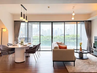 a dining room and living room with a table and chairs at Expansive Luxury 2BR - Ultra Fast Wifi - Phrom Phong in Bangkok