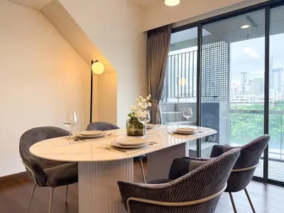 a dining room with a table and chairs at Expansive Luxury 2BR - Ultra Fast Wifi - Phrom Phong in Bangkok