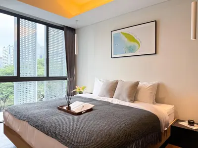a bedroom with a large bed and large windows at Expansive Luxury 2BR - Ultra Fast Wifi - Phrom Phong in Bangkok