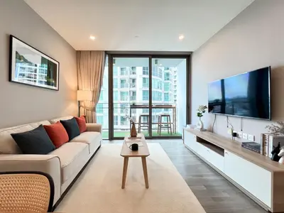 a living room with a couch and a flat screen tv at Modern elegance 2B Ultra Fast WiFi BTS Phrakhanong in Bangkok