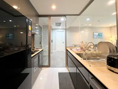 a large kitchen with a counter and a sink at Modern elegance 2B Ultra Fast WiFi BTS Phrakhanong in Bangkok