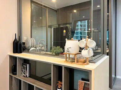 a kitchen counter with dishes on top of it at Modern elegance 2B Ultra Fast WiFi BTS Phrakhanong in Bangkok