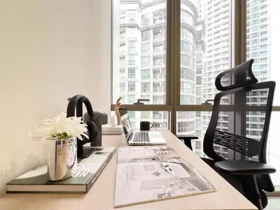 an office with a desk with a laptop and a chair at Modern elegance 2B Ultra Fast WiFi BTS Phrakhanong in Bangkok