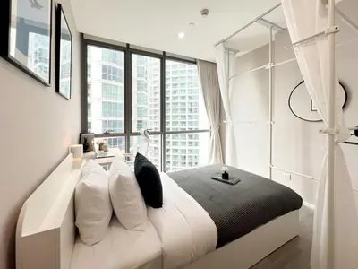 a bedroom with a bed with a large window at Modern elegance 2B Ultra Fast WiFi BTS Phrakhanong in Bangkok