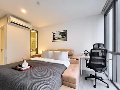a bedroom with a bed and a desk and a chair at Modern elegance 2B Ultra Fast WiFi BTS Phrakhanong in Bangkok