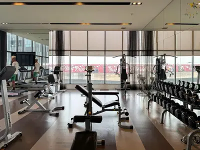 a gym with tread machines and people in the background at Cozy Park-view 1BR - Ultra Fast Wifi - BTS Bangna in Bangkok