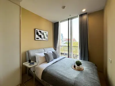 a bedroom with a bed and a large window at Luxurious Downtown 1BR - Ultra Fast WiFi - BTS Asoke in Bangkok