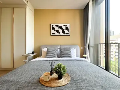 a bedroom with a large bed with a tray on it at Luxurious Downtown 1BR - Ultra Fast WiFi - BTS Asoke in Bangkok