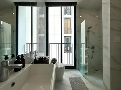 a bathroom with a tub and a shower and a toilet at Luxurious Downtown 1BR - Ultra Fast WiFi - BTS Asoke in Bangkok