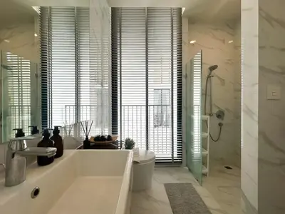 a bathroom with a tub and a toilet and a sink at Luxurious Downtown 1BR - Ultra Fast WiFi - BTS Asoke in Bangkok