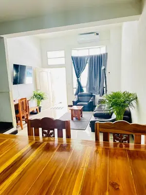 a living room with a wooden floor and a living room with a couch at Bangkok Halwa home in Sathani Ban Hua Mak