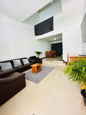 a living room with a couch and a table at Bangkok Halwa home in Sathani Ban Hua Mak