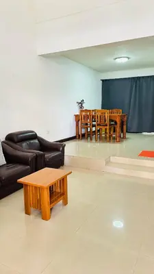 a living room with a couch and a table at Bangkok Halwa home in Sathani Ban Hua Mak