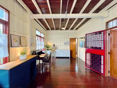a room with a hallway with a table and chairs at Entire House 3BR - White and Green Guesthouse in Bangkok Yai